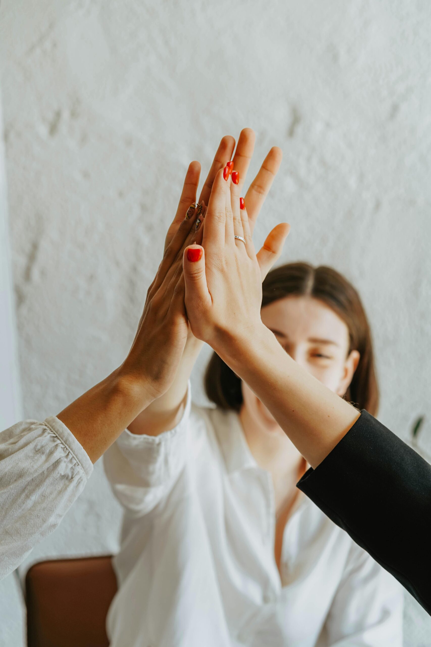 Parent and child giving a high five, representing encouragement and positive parenting